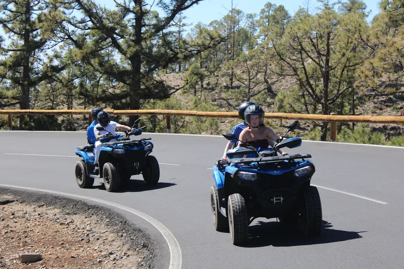 Tourists driving double quad bike on winding roads of Teide National Park