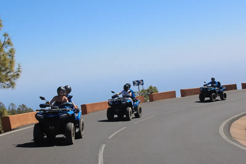 Majestic Teide volcano peak rising above pine forests during quad excursion