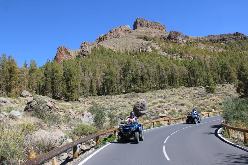 Quad bikers stopping for photo session during golden hour in Teide