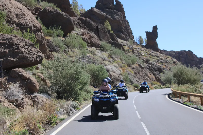 Adventure seekers riding automatic 550cc quad bikes on Mount Teide stop