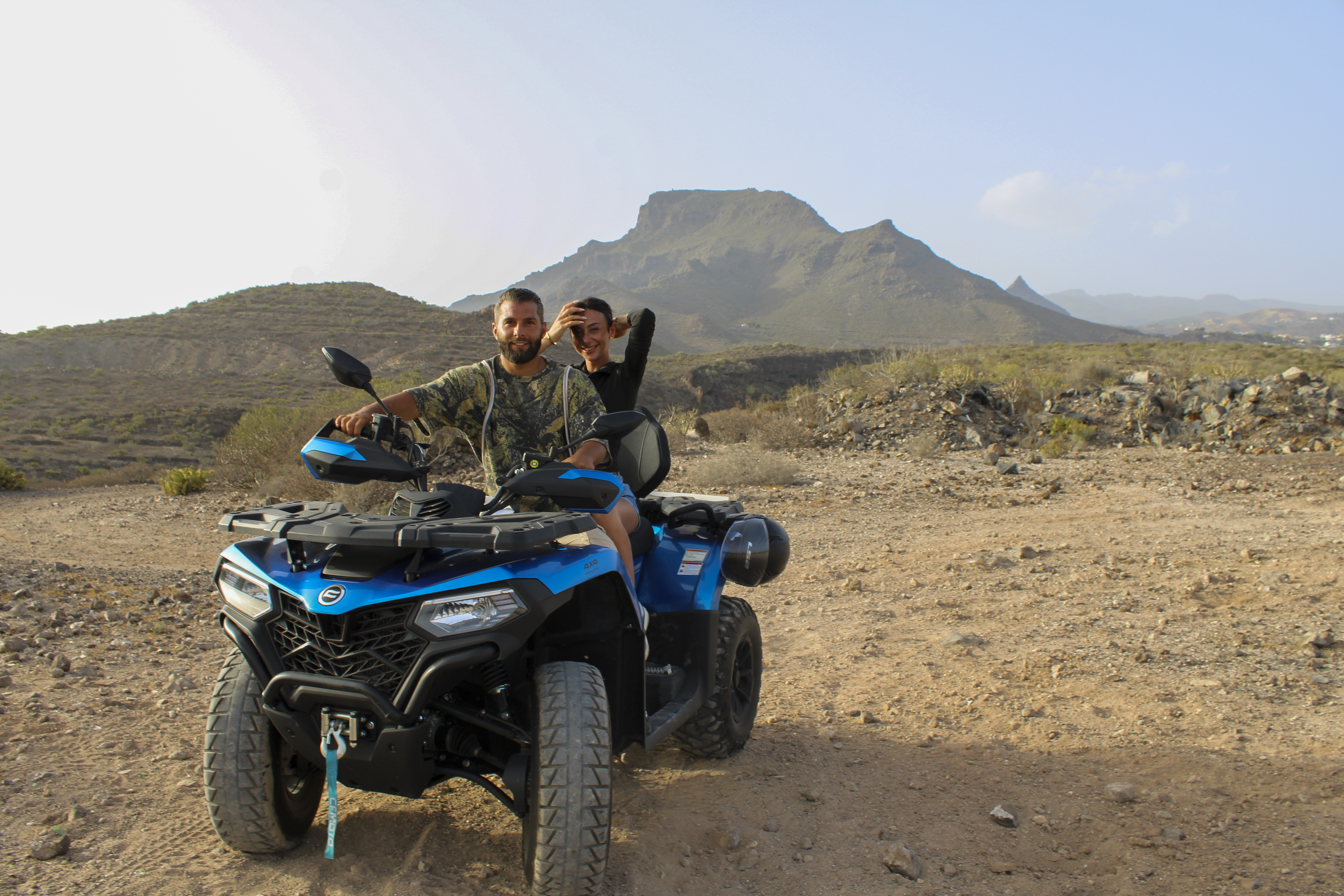 Couple riding a premium double quad bike on an off-road trail in Tenerife