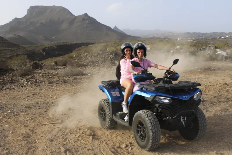 Premium quad bikes lined up on a scenic mountain road in Tenerife